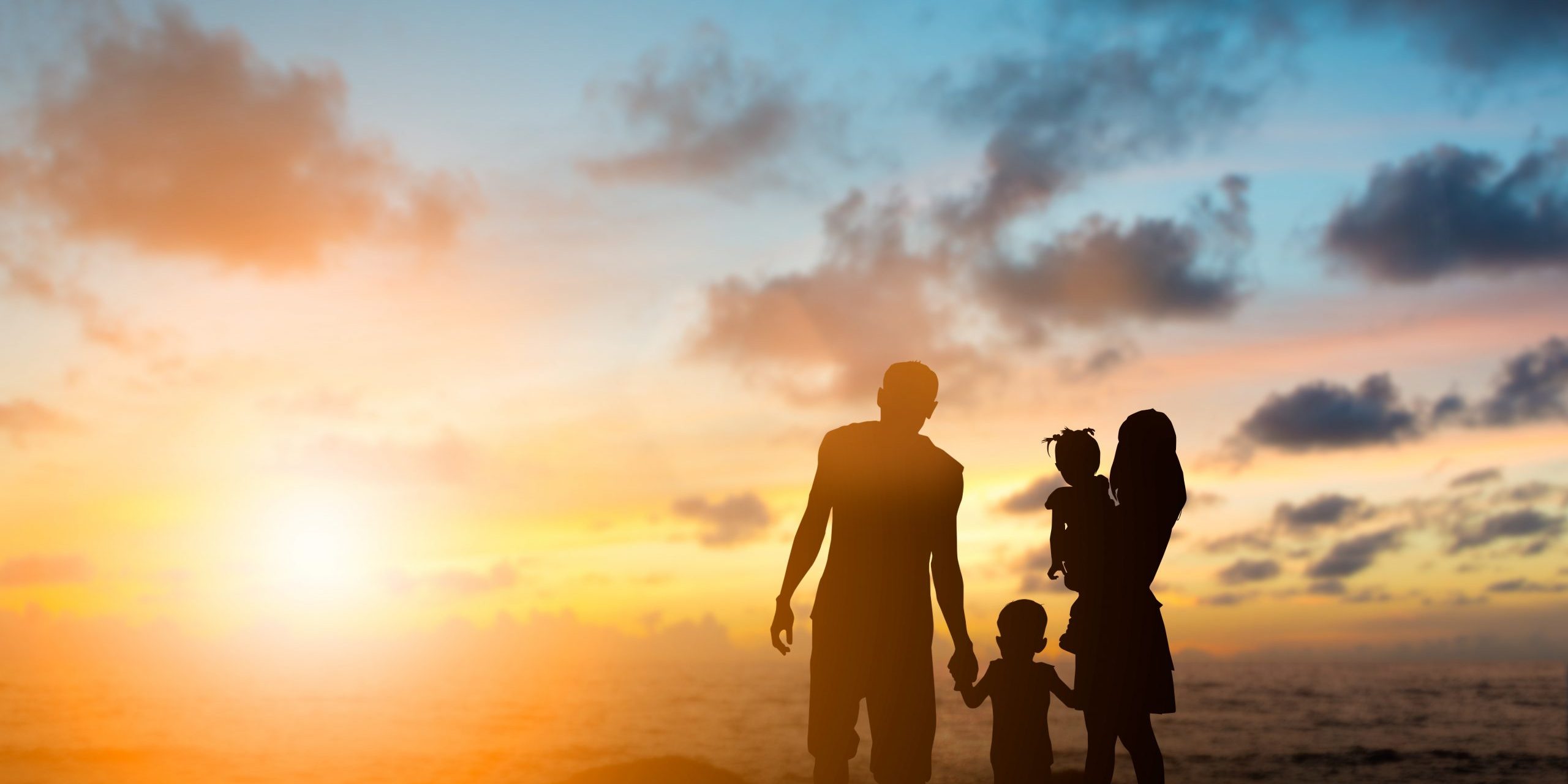 Silhouette family mother, father and young son holding hands, taking a swim in the sea for the first time the children are excited and delighted over blurred beautiful nature.Concept friendly family.flare light.selected focus